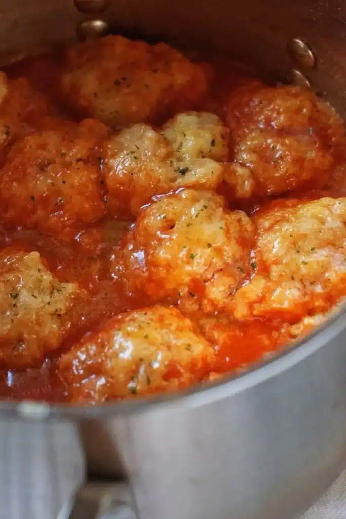 Creamy tomato soup served with cheddar bay dumplings in a bowl