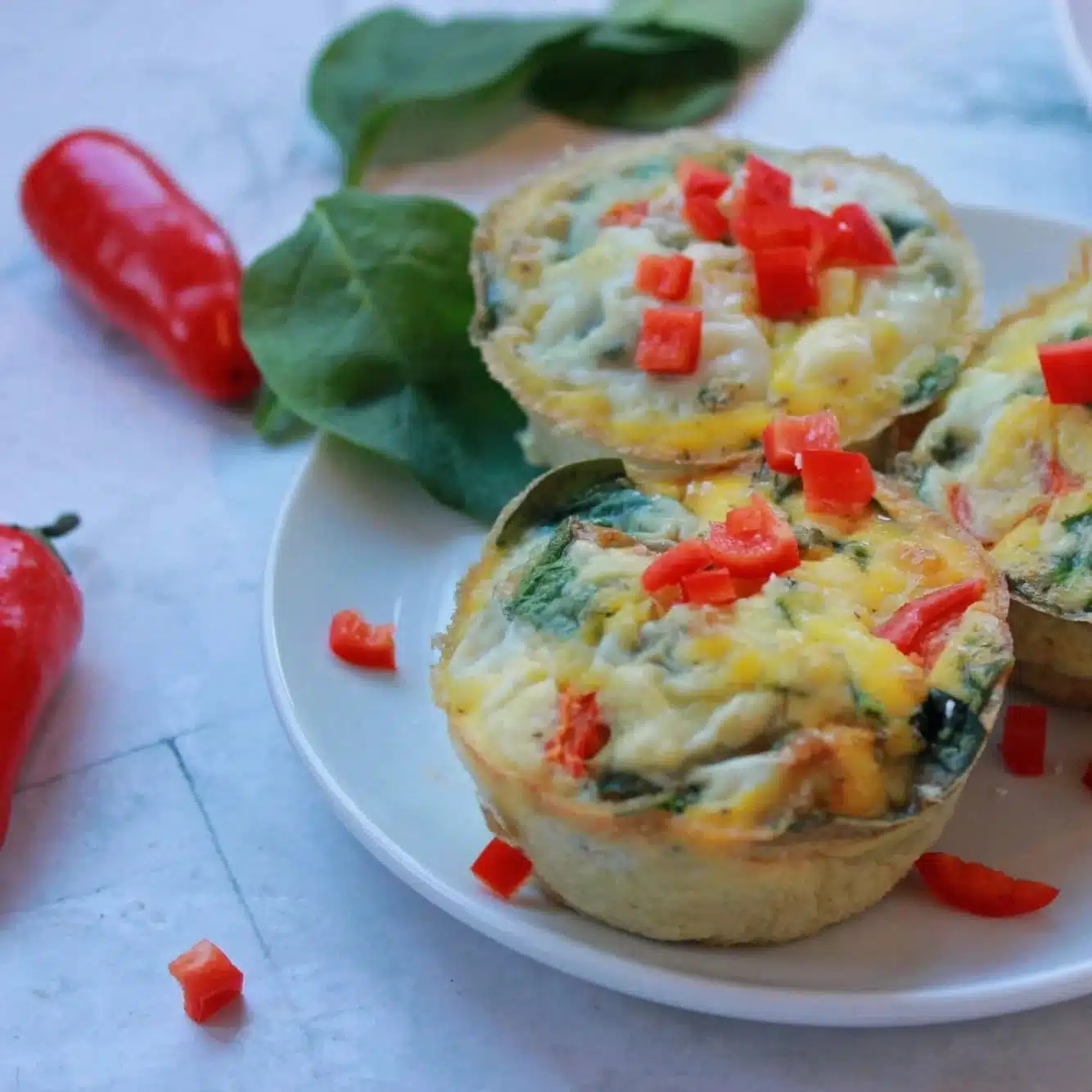 Mediterranean Egg Muffin Cups 1 Mediterranean Egg Muffin Cups with vegetables and herbs in muffin tin