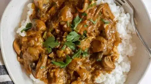 Vegan mushroom stroganoff served in a bowl with herbs and spices.