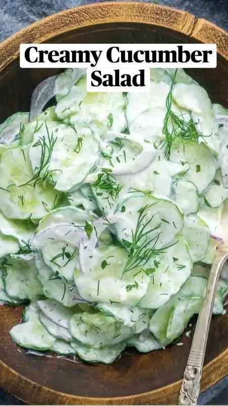 Creamy cucumber salad served in a bowl with fresh herbs and spices.
